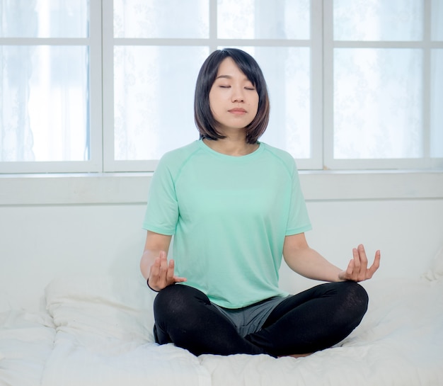 Young smiling attractive yogi woman practicing yoga