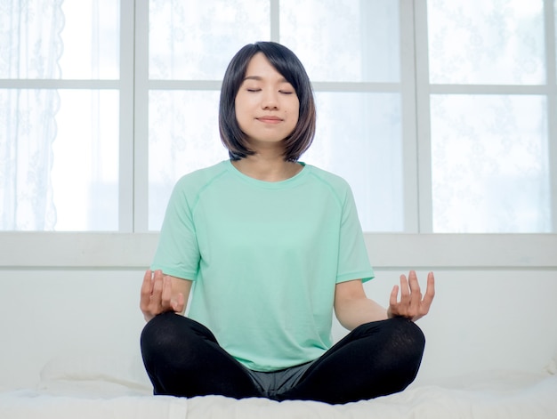 Young smiling attractive yogi woman practicing yoga