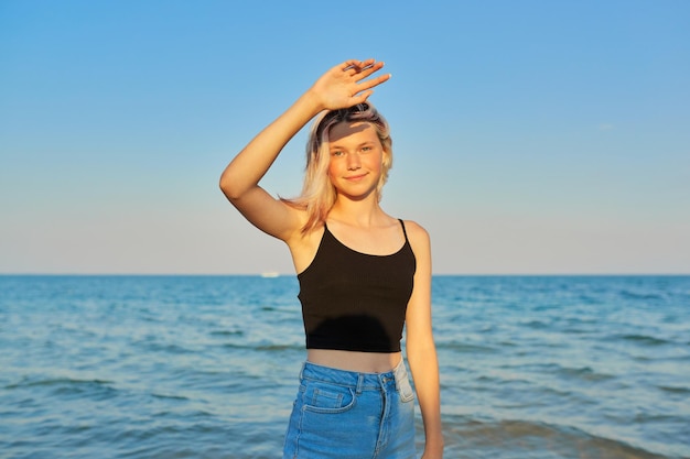 Young smiling blonde model vacation and relaxation on the seashore