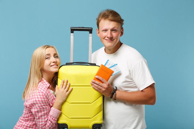 Young smiling couple two friends guy and woman in white pink t-shirts posing 