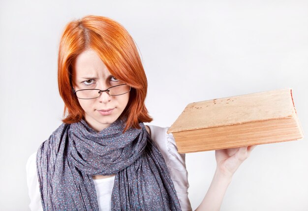 Young smiling fashion girl in glasses with age book.