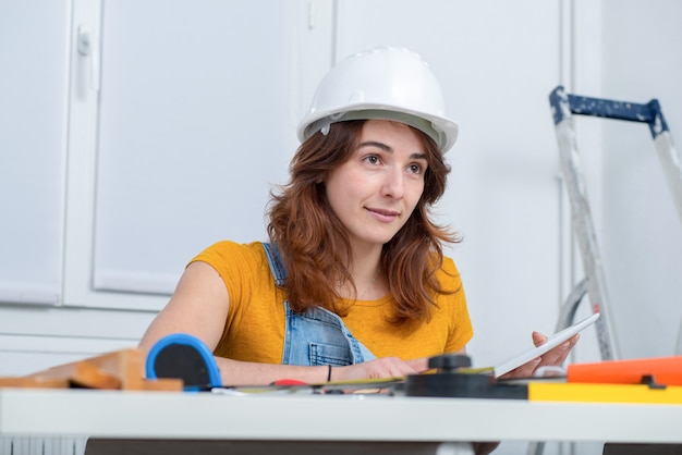 Young smiling female architect in the office