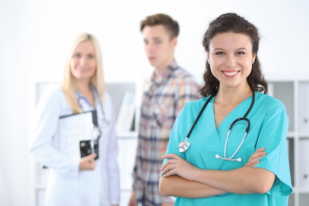 Young smiling female surgeon doctor standing at hospital. Medicine and health care concept.