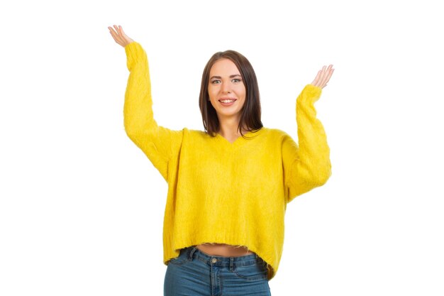 Young smiling girl in a yellow sweater Isolated