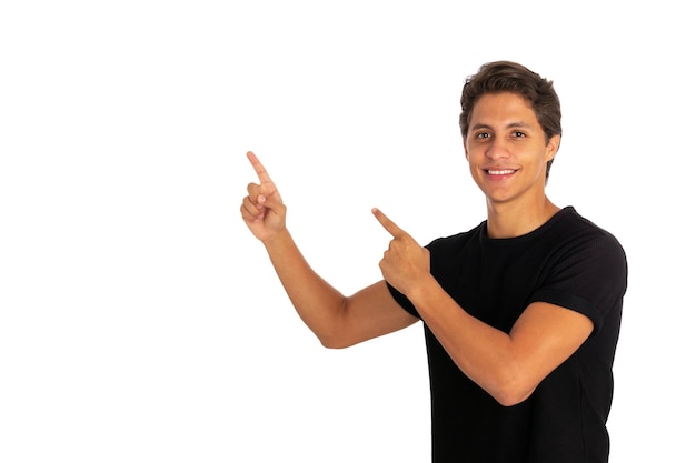 Young smiling man against a white background isolated excited pointing with forefingers