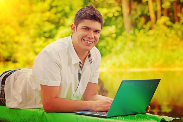 A young smiling men with laptop instagram color