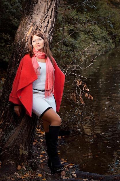 Young smiling woman in autumn park