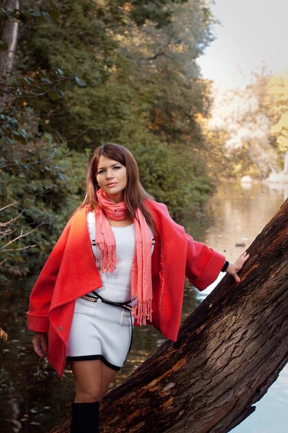 Young smiling woman in autumn park