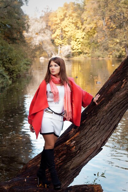 Young smiling woman in autumn park