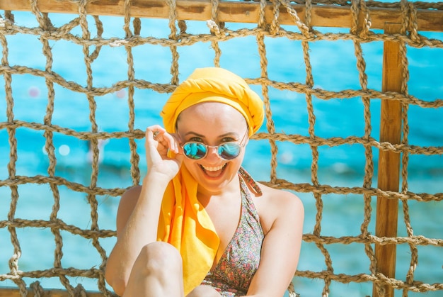 young smiling woman enjoying vacation at the sea