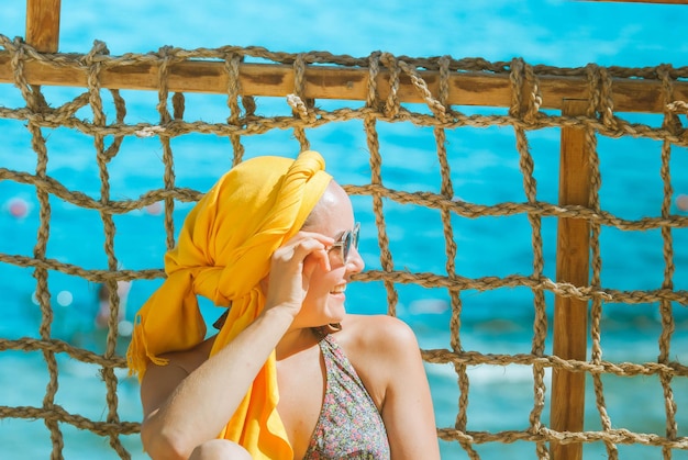 young smiling woman enjoying vacation at the sea