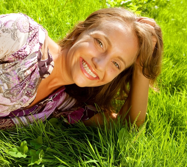 Young smiling woman on the grass