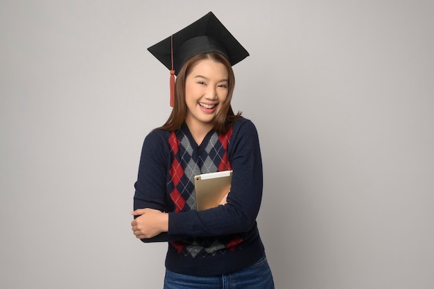 Young smiling woman holding graduation hat education and university conceptx9