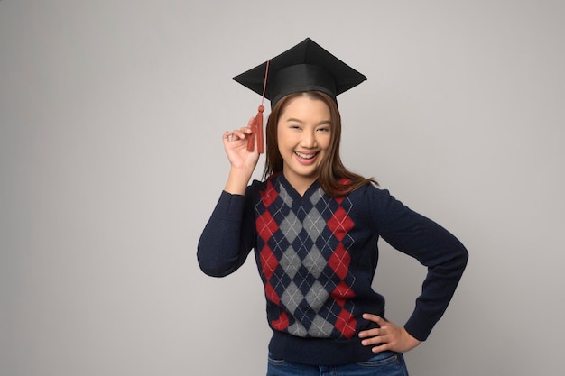 Young smiling woman holding graduation hat education and university conceptx9