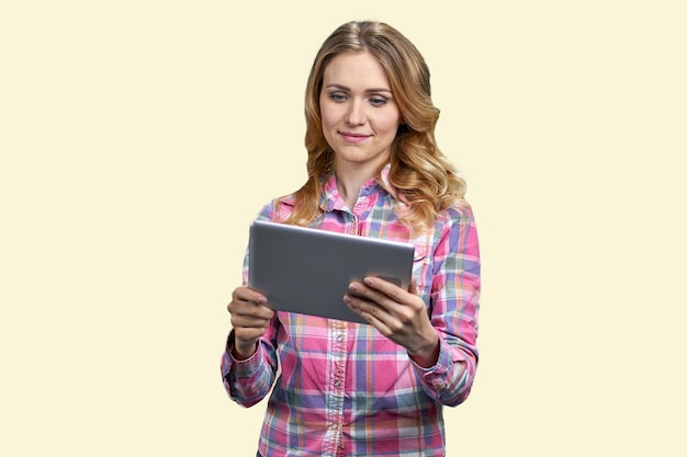 Young smiling woman looking at tablet pc isolated on white background pretty girl having video call