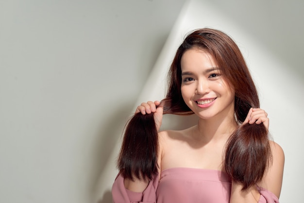 Young smiling woman outdoors portrait. Soft sunny colors.Close portrait. beautiful smiling girl. Woman in the city in summertime. Summer outdoor portrait