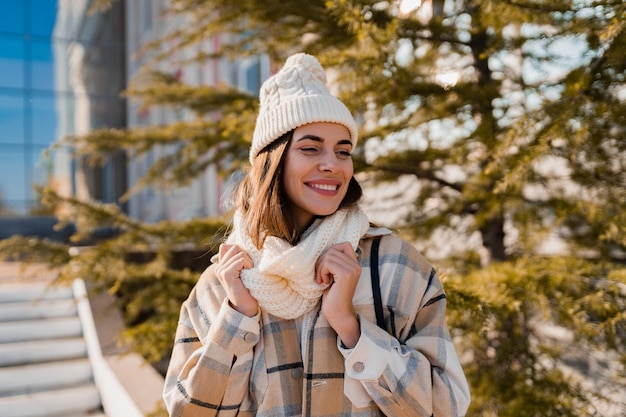 Young smiling woman walking in street in winter