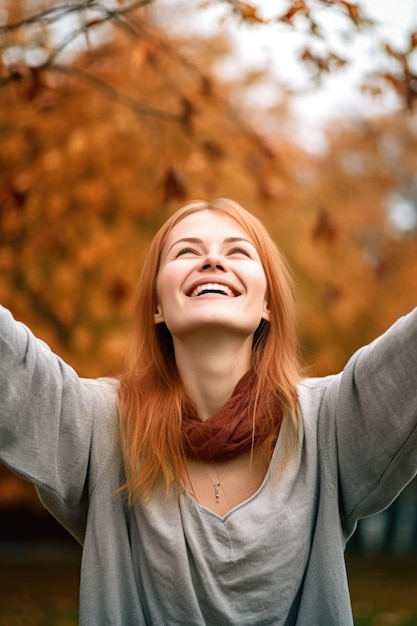 Young smiling woman with her hands cupped in the air while outdoors