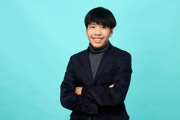 Young Southeast Asian man in light blue studio isolated background