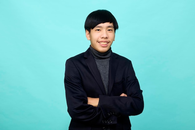 Young Southeast Asian man in light blue studio isolated background