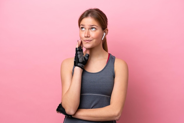 Young sport caucasian woman isolated on pink background thinking an idea