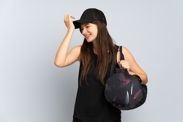 Young sport girl with sport bag isolated on grey has realized something and intending the solution