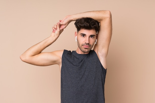 Young sport man stretching arm