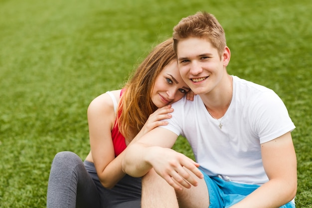 Young sport people sitting on the grass