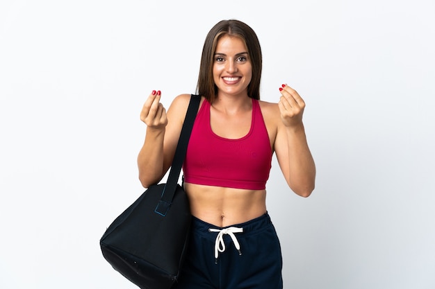 Young sport Uruguayan woman with sport bag isolated