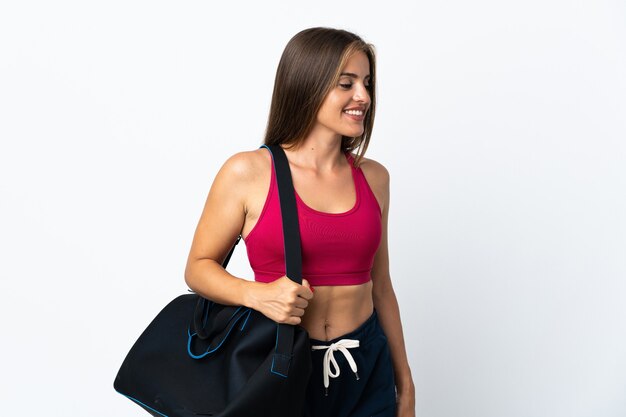 Young sport Uruguayan woman with sport bag isolated