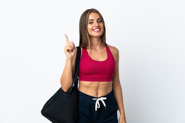 Young sport Uruguayan woman with sport bag isolated