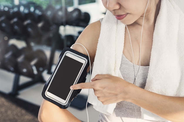 Young sport woman in gym using smartphone, Fitness ,training lifestyle concept