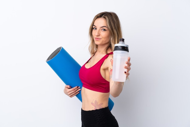 Young sport woman over isolated wall