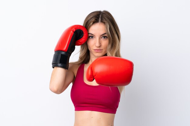 Young sport woman over isolated wall