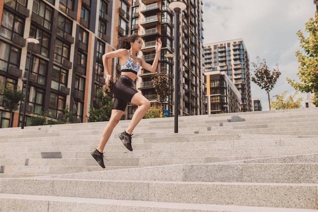 Young sportive girl having a workout outside