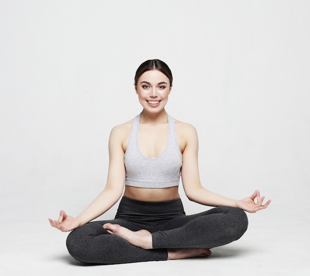 Young sporty attractive woman practicing yoga