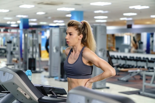 Young sporty Woman On Running Machine In Gym