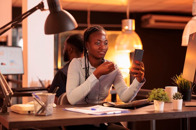 Young startup employee using remote videocall conference to talk to business people about corporate paperwork. Chatting on online teleconference call meeting, video telework on webcam.