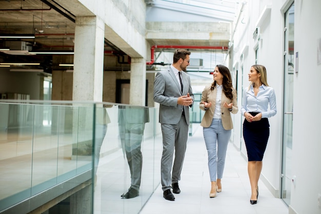 Young startup team have a discussion while walking in the office corridor