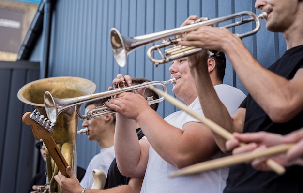 Young street music band play a lot of musical instruments