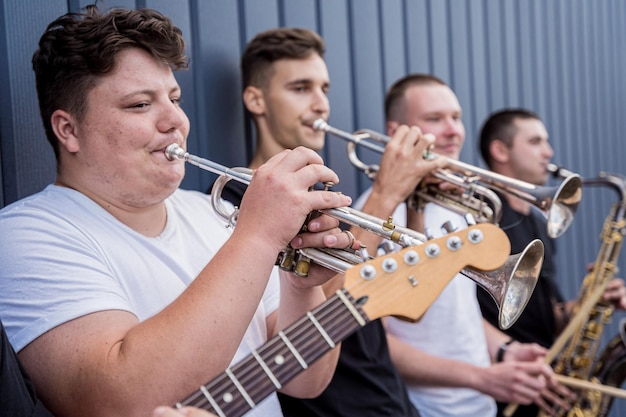 Young street music band play a lot of musical instruments