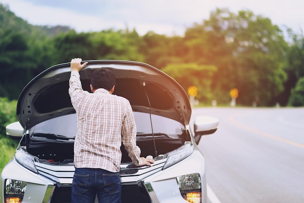 Young stressed man having trouble with his Stress broken car  Engine room crash at failed engine Wait for help