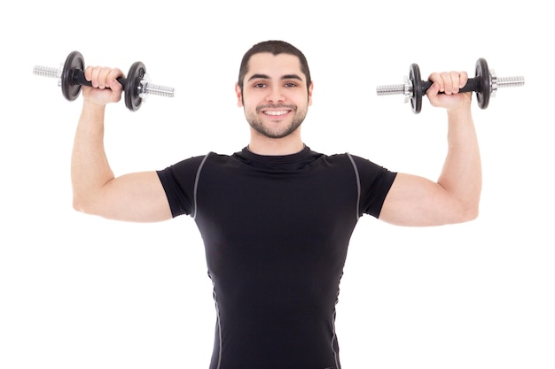 Young strong man in black sportswear doing exercises with dumbbells isolated on white background