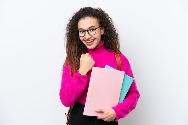 Young student Arab woman isolated on white background celebrating a victory