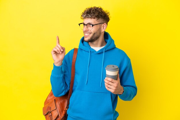 Young student blonde man isolated on yellow background pointing up a great idea