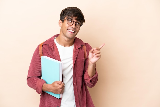 Young student caucasian man isolated on ocher background intending to realizes the solution while lifting a finger up