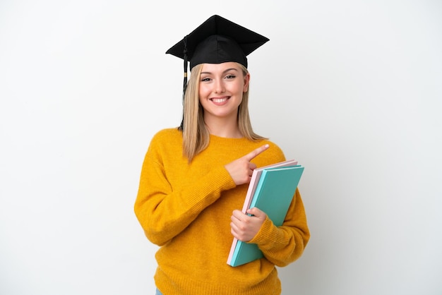 Young student caucasian woman isolated on white background pointing to the side to present a product