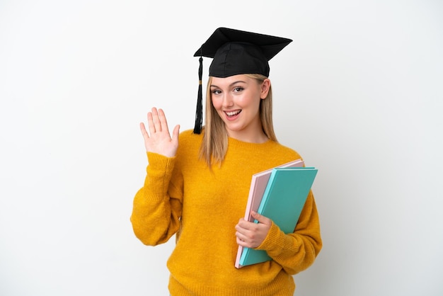 Young student caucasian woman isolated on white background saluting with hand with happy expression