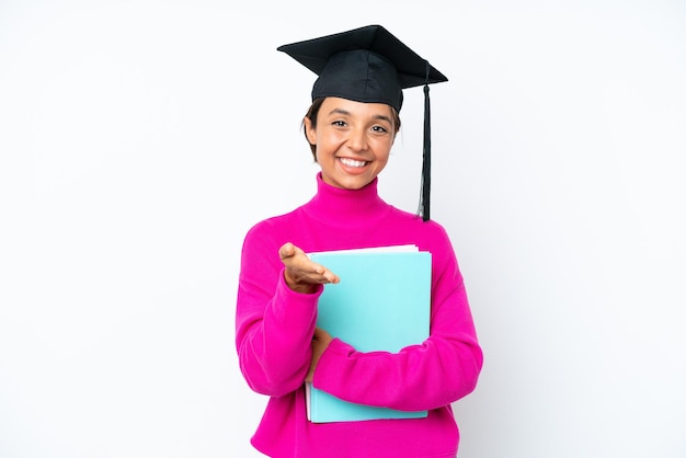 Young student hispanic woman holding a books isolated on white background shaking hands for closing a good deal