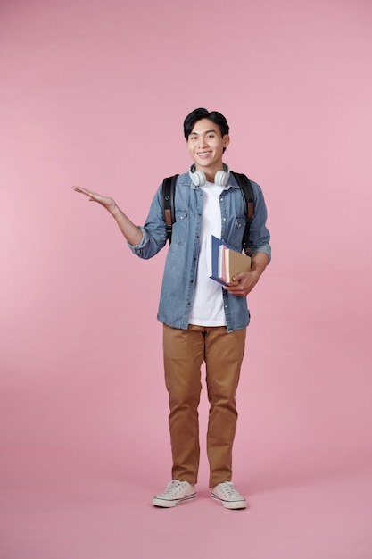 Young student man happy for understand something over isolated pink background